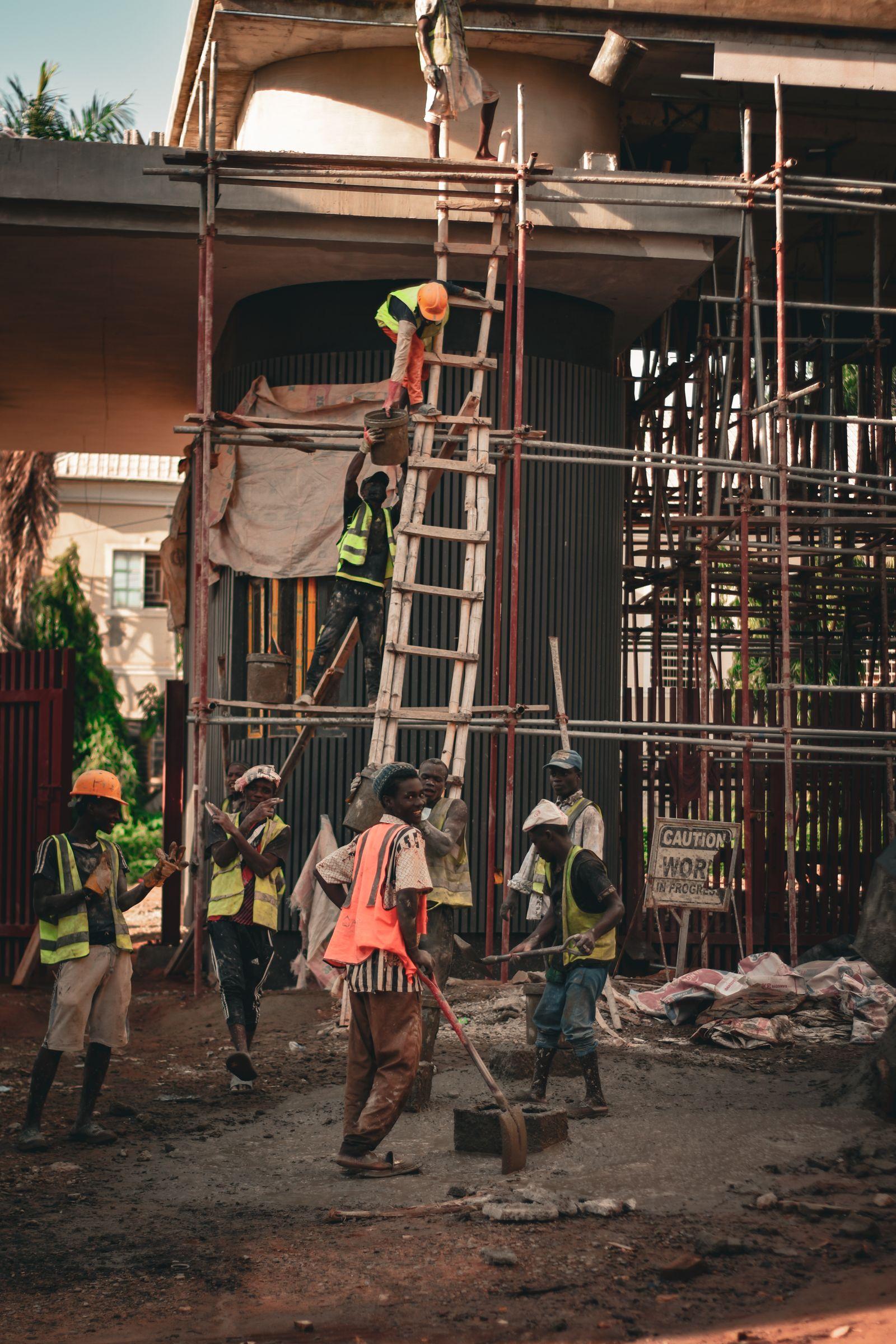 Construction workers on scaffolding at a building site